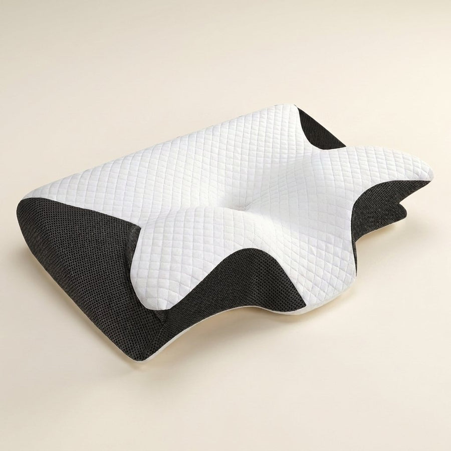 Kirafy AirAlign contour memory foam pillow, white quilted top with charcoal mesh sides, on a cream background