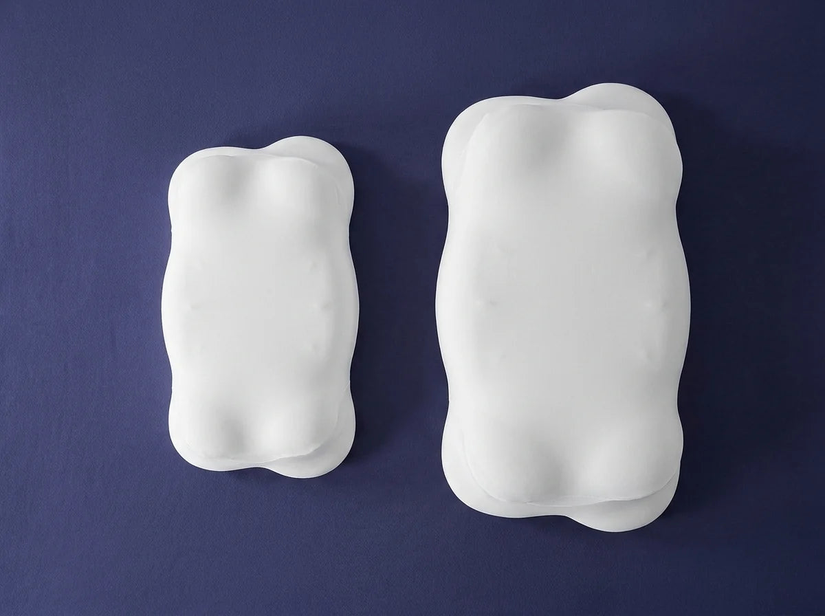 The Standard and Large WingAlign pillows photographed side by side on an indigo background, showing the difference in size between them.